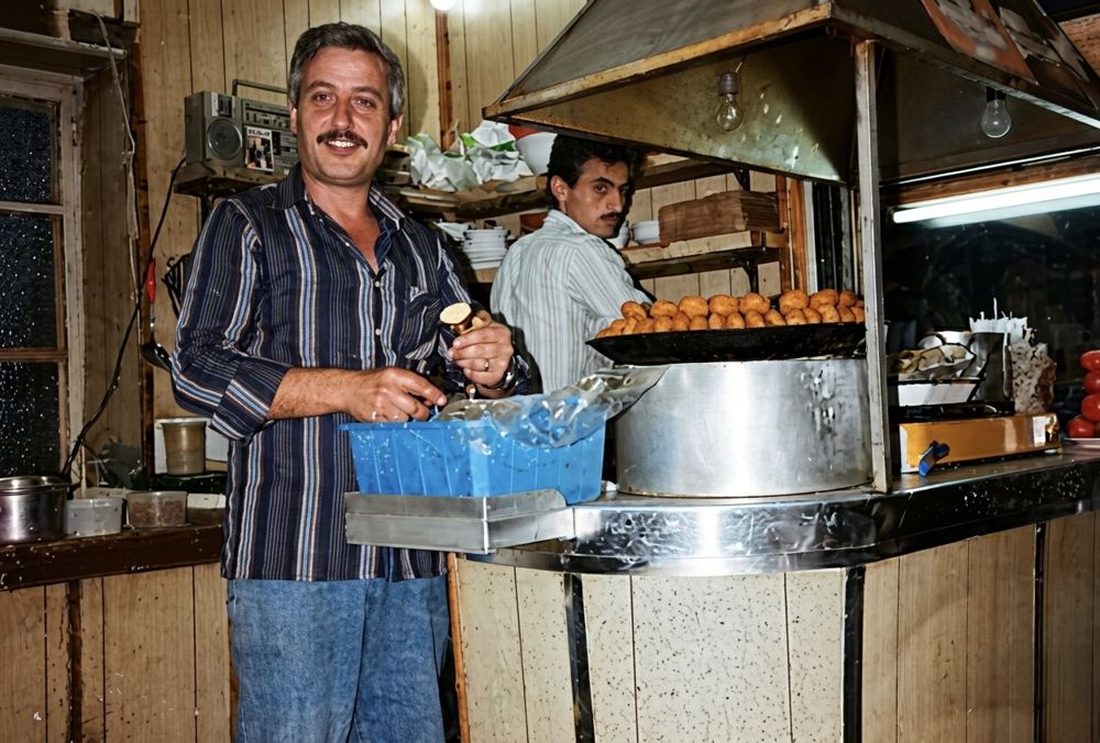 Raffoul Takeaway, frying falafel behind the counter